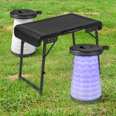 two plastic stools sitting on top of a grass covered field