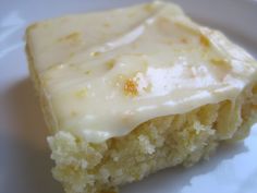 a piece of cake sitting on top of a white plate covered in frosted icing