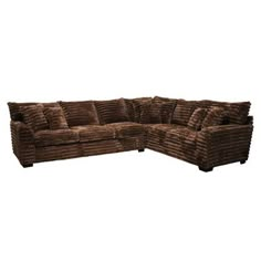 a brown sectional couch with pillows on it's back and the seat folded out