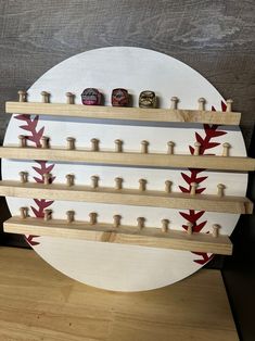 a baseball themed shelf with three bottles on it and two pegs in the middle