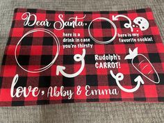 a red and black plaid table cloth with white lettering on it