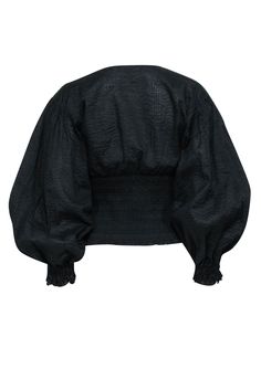 With a cool popcorn texture and smocked detailing, this black blouse by Frame is a dream. It's both effortless and stylish, a seemingly simple piece that elevates denim pants, leather skirts, and pleated shorts alike. Size S Shell 100% Cotton Lining 100% Polyester Smocked waist and sleeve cuffs V-neckline Balloon sleeves Semi sheer Bust 37" Waist 28" Shoulder to hem 20" Sleeve length 22.5" Elegant Black Blouse With Smocked Cuffs, Black Cropped Tops With Smocked Back, Black Blouse With Elastic Sleeves For Work, Black Cropped Blouse For Fall, Chic Cropped Smocked Top For Fall, Black Long Sleeve Top With Smocked Bodice, Fitted Black Blouse With Elastic Sleeves, Black Tops With Puff Blouson Sleeves, Black Blouse With Smocked Bodice For Fall