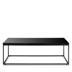 a black coffee table sitting on top of a white floor next to a metal frame