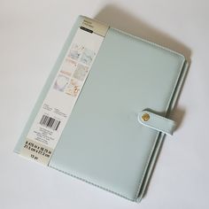 a blue binder with a bar on it sitting on top of a white table