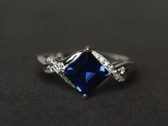 Welcome to my shop, you can find many beautiful gemstone jewelry here, and you also can ask for customized service. Main Stone: lab created sapphire, square cut, measures 7X7mm, weight 2.27 carats;Accent Stones: CZMetal: 925 sterling silver plated with rhodium. I also can provide metal options such as 14k solid yellow/white/rose goldSetting: prong settingMy shop home: https://www.etsy.com/shop/XCjewelryStudio?ref=hdr_shop_menuIt's a perfect gift for the person who was born in September (Birthsto Blue Gemstone Ring, Blue Engagement Ring, Sapphire Wedding Rings, September Birthstone Rings, Blue Gemstone Rings, Blue Sapphire Ring, London Blue Topaz Ring, Sapphire Engagement Ring Blue, Sapphire Wedding