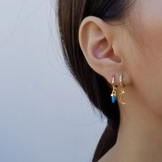 "Bring a little celestial whimsy to your look with the star (moon) charms dangling from these lobe-hugging loops of 16k gold plate. ♥ 16k gold plated over brass ♥ Diameter of hoop: outer - 12 mm / inner - 7.5 mm ♥ Measurement of pendants: star - 8 mm tall and width / moon - 9.5 mm tall and 7 mm width ♥ Sold as single (ONE earring) or a pair ♥ Latch back ♥ Nickel free ♥ All items are packed inside an elegant Gold Spoon jewelry box. If you are purchasing a product to send as a gift, we can send th Celestial Dangle Huggie Earrings As Gift, Celestial Dangle Huggie Earrings For Gift, Moon Charm Huggie Earrings, Celestial Huggie Earrings As Gift, Celestial Huggie Pierced Earrings, Dainty Huggie Earrings With Moon Charm, Celestial Style Drop Earrings, Dainty Moon Shaped Single Earring, Dainty Single Moon Earring