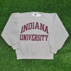 Vintage 80s Indiana University Sweatshirt Small 19x23 USA Own a piece of 80s nostalgia with this vintage Indiana University sweatshirt, made in the USA. Small 19x23, perfect for retro lovers.  * Used condition  * Length is on the shorter side  * No rips/holes  * No stains  * Normal fading from washing  * Normal cracking on the graphic VINTAGE INDIANA SWEATSHIRT, 80S SWEATSHIRT, INDIANA UNIVERSITY, SMALL SWEATSHIRT, 19X23 SWEATSHIRT, MADE IN USA, RETRO COLLEGE GEAR, VINTAGE 80S CLOTHING, INDIANA HOOSIERS, SMALL VINTAGE SWEATSHIRT 73767 Indiana University Merch, Vintage Long Sleeve T-shirt For College, Vintage College T-shirt With Lettering, Vintage Crew Neck Tops With Lettering, Throwback Long Sleeve T-shirt For College, Retro Cotton Sweatshirt With Screen Print, Vintage Crew Sweatshirt For College, Retro Long Sleeve Pre-shrunk Sweatshirt, Vintage Long Sleeve College T-shirt