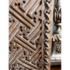 an intricate carved wooden door with carvings on it