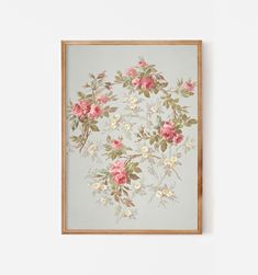 a painting hanging on the wall next to a wooden frame with flowers painted on it