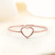 Show your love for her with our shaped dainty ring. It features a light dainty band, and a cute heart shape on top to always remind her of your love. Stack great with our other rings as well! Available in your choice of: Solid 14k & 18K Golds, Silver, or Gold Plated over Silver Base 1.2mm-1.4mm average width Simple Heart Midi Rings, Elegant Adjustable Heart-shaped Stackable Rings, Minimalist Heart Cut Stackable Rings, Delicate Rose Gold Heart Ring, Simple Heart-shaped Rings For Valentine's Day, Simple Heart Rings For Valentine's Day, Simple Heart Promise Ring For Valentine's Day, Minimalist Rose Gold Heart Ring In Sterling Silver, Adjustable Stackable Rose Gold Heart Ring