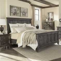 a bedroom with a bed, dresser and night stand