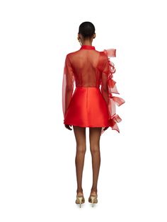 Frank Aghuno crafts elegant silhouettes from sumptuous fabrics to challenge societal notions of how Nigerian women are expected to dress. This dramatic shirt and skirt set is cut from smooth tulle and embellished with oversized crinoline bows on the transparent top. The mini skirt boasts a form-fitting silhouette with a refined minimalist construction. Wear yours to evening events where making an entrance is a must.- Point collar, button fastening on shirt, concealed back zip fastening on skirt- Sheer Spring Party Sets, Chic Organza Evening Sets, Evening Organza Sets With Ruffles, Chic Evening Sets In Organza, Fitted Evening Sets With Sheer Sleeves, Summer Party Organza Sets, Glamorous Organza Party Sets, Evening Sets With Sheer Sleeves And Fitted Design, Organza Party Sets With Sheer Sleeves