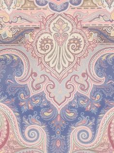 an ornate paisley design in blue, pink and white