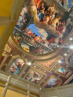 the ceiling is painted with many paintings