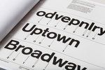 an open book with black and white typograms on the front cover that reads,'overnight up town broadway '