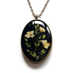 An unique real flower resin necklace. Want to gift your bridesmaids or you near and dear ones with a amazing piece of nature? Then you have got the right one. This exceptional real flower forest necklace has been created with delicate herbs and flowers collected from majestic mountains of Himalaya and then carefully processed to preserve intrinsic colour and shape. Dried and pressed real flowers were then handcrafted to unique design and embedded into high quality resin to provide everlasting va Botanical Pressed Flower Wedding Jewelry, Nature-inspired Flower Pendant Necklace For Weddings, Nature-inspired Pressed Flowers Jewelry For Wedding, Nature-inspired Pressed Flower Wedding Jewelry, Nature-inspired Pressed Flowers Wedding Jewelry, Nature-inspired Birth Flower Necklaces For Weddings, Nature-inspired Wedding Necklaces With Birth Flower, Nature-inspired Wedding Necklace With Birth Flower Details, Flower Shaped Locket Necklaces For Weddings