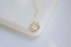 "Delicate, handmade gold circles necklace, perfect for wearing everyday or for layering with others.  Made from recycled 9ct gold, the two interlocking circles have a lightly textured finish, giving the necklace an organic feel. The size is small with each circle having an outer diameter of approximately 10mm (please check you are happy with this size as the macro photography can make items look bigger than they are!) It comes on a delicate 9ct gold 0.8mm belcher chain, there are 2 chains length Circles Necklace, Yard Wedding, Gold Circle Necklace, Belcher Chain, Solid Gold Necklace, Branded Gifts, Metallic Foil, Circle Necklace, Handmade Gold