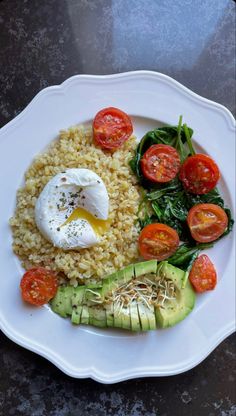 a white plate topped with rice and veggies