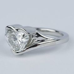 a white gold ring with a heart shaped diamond on it's shants, set in 18k white gold