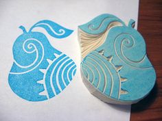 two rubber stamps with blue designs on them