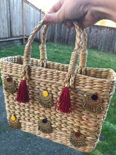 A lovely handmade open cane basket with beautiful trinkets and tassels. Carry it with you for your small beach accessories (sun screen, sun shades, hat, beach flip flops, etc.)  Or use it for your Easter eggs this time Or put in some different use. Multiple uses, pick your choice. Bag size: 11 inches x 8 inches x 3 inches Cane bag; Woven cane bag; Cane basket; Vintage cane bag; Cane accessories bag; Cane purse; Accessory bag; Beach purse; Beach bag; Easter basket; Cane Easter basket; Easter bag Bohemian Straw Bag With Tassels For Daily Use, Bohemian Straw Tote Bag With Tassels, Bohemian Straw Bag With Tassels, Bohemian Straw Shoulder Bag, Bohemian Straw Crochet Bag, Bohemian Jute Bag With Tassels, Bohemian Straw Beach Bag, Bohemian Braided Rectangular Bag, Rectangular Natural Straw Bag With Tassels