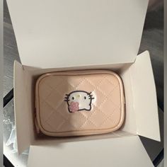 an open hello kitty wallet in a box