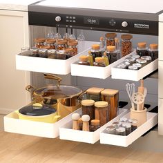 an organized kitchen drawer with spices and utensils on the bottom shelf for storage