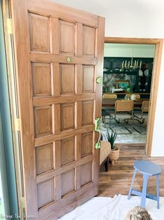 a dog laying on the floor in front of a wooden door