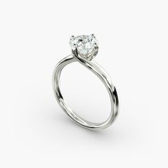 a white gold engagement ring with an oval cut diamond in the center and a twisted band around it