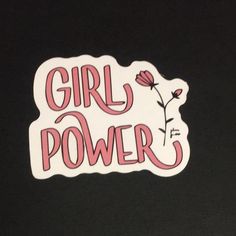 the girl power sticker is pink and white with red lettering on it, against a black background