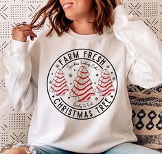 Farm Fresh Christmas Tree Sweatshirt, Christmas Tree Cake T-shirt, Christmas Cake Sweatshirt, Christmas Crewneck, Christmas Shirt For Women 📢Please Check All Photos For Details.   📢Choose Your T-Shirt Size From The Drop-Down Lists Next To The item Picture   📢Choose Of Your T-Shirt Color From The 2nd Picture   📢Use "Add message to Seller" link On The Checkout Page To Send me the Following important Details For Your Order's Customization.   📢Shipping Time Varies by location (we are located in Sugar Land, Texas) please consider that our turn around time is 1 to 3 business days.   ⭐Which brand do you use for t-shirts? We use Gildan Soft Style, Bella Canvas Unisex, Rustic United, Outlash, Tees Factory, Hanes, Comfort Color District and Next Level when we have a shortage of stocks for certa Christmas Tree Cakes, Feliz Halloween, Christmas Tree Cake, Fresh Christmas Trees, Merry Christmas Svg, Tree Cakes, Christmas Gift Idea, Svg Christmas, Holiday Shirts