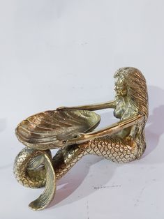 a bronze figurine sitting on top of a table