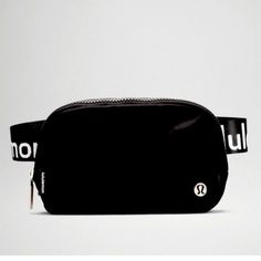 a black fanny bag with the word no u on it and a white belt strap