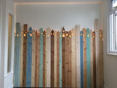 a wooden fence with candles on it in front of a window