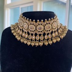 Introducing this gorgeous choker set made from fine quality polki stones. Handcrafted with fine quality Gold pearls, this set is a perfect neutral set. Comes with a pair of earrings and tikka ( headpiece). ALL SALES ARE FINAL. KINDLY MESSAGE ME FOR ANY INQUIRIES. Temple Jewelry Style Choker Necklace For Receptions, Temple Jewelry Style Choker For Receptions, Bollywood Style Kundan Necklace With Jewels, Choker Necklaces For Receptions And Festivals, Festive Jeweled Wedding Choker, Festive Wedding Jeweled Choker, Gold Choker Jewelry Set For Reception, Silver Tilla Choker For Reception, Tilla Choker Jewelry For Reception