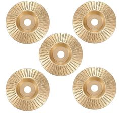 four gold metal discs on a white background