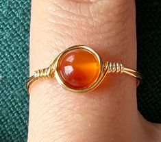 Handmade wire-wrap rings with real agate stone beads! This is my listing for rings with gold colored wire. Although each bead is unique, I have many general colors such as green, pink, orange, etc. Every single ring is made by me in my spare time as a college student! Thank you for your interest in my small business! :D Crystal Wrapped Rings, Gold Wire Wrapped Carnelian Jewelry, Wired Jewelry, Uni Student, Diy Wire Jewelry Rings, Gold Wrap Ring, Wire Jewelry Rings, Wire Wrapped Stone Jewelry, Bijoux Fil Aluminium