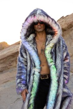 MEN’S LED DESERT WARRIOR COAT FEATURES High quality faux fur. Lined with super soft cuddle minky fabric. Fur lined hood and lapel. 2 Inside deep zipper pockets on the front sides of the coat to hold a water bottle. 2 Outside pockets to keep your hands warm. 6" Invisible zipper ID "secret" pocket on the inside left chest lining. 2 Battery pocket. 3 Hook & eye closures. Inside back pack straps to wear the coat like a cape when you are too hot. Length is shorter in the back around the knee approx. Multicolor Faux Fur Coat For Winter, Hooded Faux Fur Coat With Fluffy Detail, Hooded Fluffy Faux Fur Coat, Fluffy Hooded Faux Fur Coat, Multicolor Winter Outerwear With Faux Fur Trim, Multicolor Outerwear With Faux Fur Trim For Winter, Cold Festival Outfit, Desert Warrior, Fabric Fur