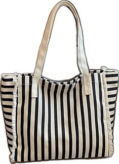 a black and white striped bag with fringes