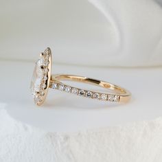 an oval shaped diamond engagement ring set in yellow gold