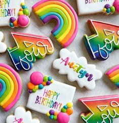 decorated cookies with happy birthday messages and rainbows on them are laid out in rows