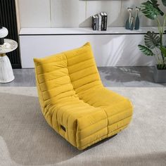 a yellow chair sitting on top of a white rug