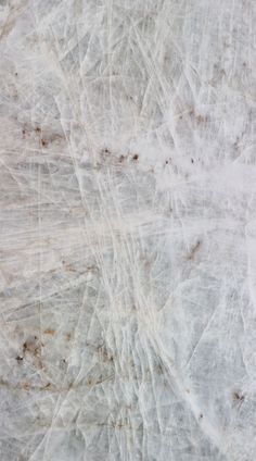 the texture of marble is white with brown spots and lines on it's surface