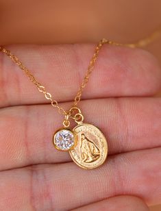 "This is a lovely Mother Mary double charm necklace. Necklace is completely made of 14kt gold filled. This beautiful pendant measures 15x11mm, has the image of the Virgin Mary on both sides along side a sparkling 6mm clear bezel. These lovely little charms come on a 14kt gold filled cable chain with spring clasp. Choose length of 16\", 18\", 20\" or 22\". Comes in a cute gift box ready to present. *Model is wearing a 16\" length in the photo. What is gold filled jewelry? Gold filled jewelry is a 14kt Gold Jewelry, Clean Sterling Silver, Jewelry Cleaning Solution, Catholic Jewelry, The Virgin Mary, Cute Gift Boxes, Clover Necklace, Charm Necklaces, Necklace Necklace