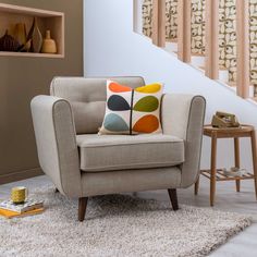 a chair sitting in front of a stair case