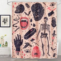 a bathroom with a shower curtain that has various items on it, including a skeleton and human body