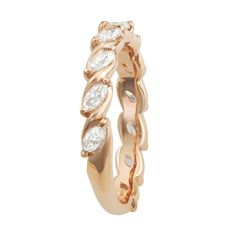 a rose gold ring with white stones on the inside and outside, set in 18k yellow gold