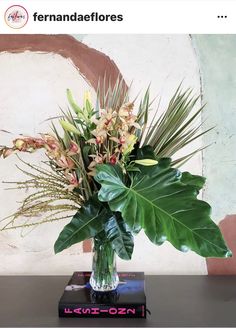 a vase filled with lots of flowers on top of a table