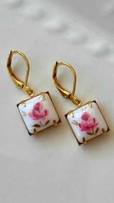 Our Vintage Rosebud Earrings feature vintage cabochons with hand painted Limoge style pink roses on porcelain.  Like flowers in bloom, no two are exactly alike. Handset in closed back raw brass settings and paired with premium raw brass lever backs. Lead and nickel free. 🎁Receive a special complimentary gift with all purchases over $35.00, while supplies last.  DETAILS: ~Many of my pieces are new vintage (new pieces featuring rare & previously uncirculated vintage elements). Because of this, ma Earrings Square, Vintage Earring, Romantic Earrings, Schmuck Diy, Vintage Elements, Redwood City, Ceramics Ideas, Pretty Jewelry, Style Pink