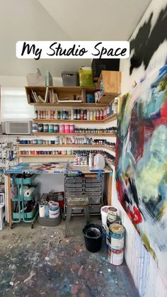 an art studio with lots of paint and supplies